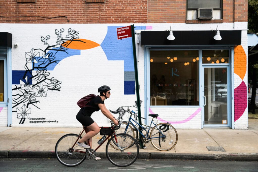 bicyclist passing a store